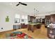 Open kitchen layout with stainless appliances, custom island, hardwood floors, and bright countertops at 838 Woodruff Place West Dr, Indianapolis, IN 46201