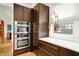 Contemporary kitchen showcasing stainless steel ovens and stylish dark wooden cabinets at 838 Woodruff Place West Dr, Indianapolis, IN 46201