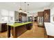 Spacious kitchen with modern appliances, dark wood cabinetry, a cooktop island, and modern fixtures at 838 Woodruff Place West Dr, Indianapolis, IN 46201