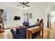 Bright living room with hardwood floors, a ceiling fan, and comfortable seating at 838 Woodruff Place West Dr, Indianapolis, IN 46201