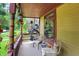 Inviting covered porch with seating, decorative lanterns, and hanging plants at 838 Woodruff Place West Dr, Indianapolis, IN 46201