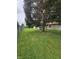 Large, fenced backyard with mature trees providing ample shade at 8433 Fairwind Ct, Indianapolis, IN 46256
