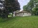 Backyard with siding and a brick chimney, with trees at 8433 Fairwind Ct, Indianapolis, IN 46256