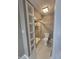 Bathroom with tiled shower, white toilet, and built-in shelving at 8433 Fairwind Ct, Indianapolis, IN 46256