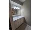 Bathroom vanity with gray walls, marble countertop, white cabinet and large mirror at 8433 Fairwind Ct, Indianapolis, IN 46256