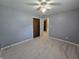 Bedroom with gray walls, neutral carpet, ceiling fan, and closet at 8433 Fairwind Ct, Indianapolis, IN 46256