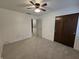 Bedroom with neutral carpet, dark wooden closet door, and entry to another room at 8433 Fairwind Ct, Indianapolis, IN 46256