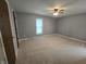 Bedroom with gray walls, neutral carpet, ceiling fan, and a window for natural light at 8433 Fairwind Ct, Indianapolis, IN 46256