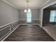 Dining room with laminate floors, chair rail, updated chandelier, and abundant natural light at 8433 Fairwind Ct, Indianapolis, IN 46256