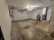 Spacious garage with a roll-up door and a concrete floor at 8433 Fairwind Ct, Indianapolis, IN 46256