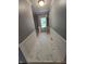 Hallway with gray walls, white trim, and marble floors at 8433 Fairwind Ct, Indianapolis, IN 46256