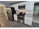 Modern kitchen features stainless steel appliances, granite countertops, and white cabinets at 8433 Fairwind Ct, Indianapolis, IN 46256