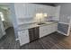 Updated kitchen with stainless steel appliances, white cabinets, granite countertops, and laminate flooring at 8433 Fairwind Ct, Indianapolis, IN 46256