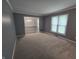 Spacious living room featuring large window, soft carpet, and neutral decor at 8433 Fairwind Ct, Indianapolis, IN 46256