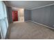 Cozy living room with neutral carpet, gray walls, and bright red front door creating a welcoming atmosphere at 8433 Fairwind Ct, Indianapolis, IN 46256