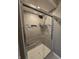 Close-up of tiled shower with glass doors and chrome fixtures at 8433 Fairwind Ct, Indianapolis, IN 46256