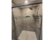 Close-up of tiled shower with glass doors and chrome fixtures at 8433 Fairwind Ct, Indianapolis, IN 46256
