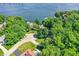 Beautiful lakefront property surrounded by lush greenery and mature trees, showcasing its serene setting at 8924 Stormhaven Ct, Indianapolis, IN 46256