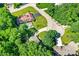 Beautiful aerial view of a home with a backyard pool, lush lawn, and mature trees at 8924 Stormhaven Ct, Indianapolis, IN 46256