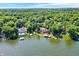 Picturesque aerial view of lakeside properties with lush trees and docks on a beautiful sunny day at 8924 Stormhaven Ct, Indianapolis, IN 46256