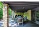 Backyard patio has outdoor dining area, stone pillars, and sliding glass doors at 8924 Stormhaven Ct, Indianapolis, IN 46256