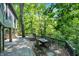 Backyard dining and relaxation patio with stone pillars, and lush landscaping at 8924 Stormhaven Ct, Indianapolis, IN 46256