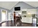 Entertaining bar with custom cabinetry, sink, mini-fridge, and pass-through to the modern eat-in kitchen at 8924 Stormhaven Ct, Indianapolis, IN 46256