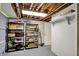 A basement with exposed ductwork, shelving, a white door and gray floors at 8924 Stormhaven Ct, Indianapolis, IN 46256