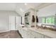 Bright bathroom featuring double sinks, a built-in shelf, and a large mirror for plenty of natural light at 8924 Stormhaven Ct, Indianapolis, IN 46256