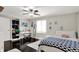Bright bedroom with a ceiling fan, hardwood floors, a desk and open shelving at 8924 Stormhaven Ct, Indianapolis, IN 46256