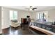 Comfortable bedroom with dark floors, a ceiling fan, and an adjacent desk area at 8924 Stormhaven Ct, Indianapolis, IN 46256