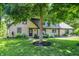 Stunning two-story stone house with well-manicured landscaping and mature trees at 8924 Stormhaven Ct, Indianapolis, IN 46256