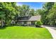 Beautiful home featuring stone accents, manicured lawn, and mature trees in a serene setting at 8924 Stormhaven Ct, Indianapolis, IN 46256