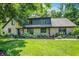 Charming stone-clad home featuring a lush green lawn and meticulously landscaped flower beds at 8924 Stormhaven Ct, Indianapolis, IN 46256