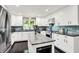 Bright kitchen featuring white cabinets, stainless steel appliances, and a center island with a marble countertop at 8924 Stormhaven Ct, Indianapolis, IN 46256