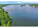 Scenic aerial view of a vast lake surrounded by lush greenery, capturing its beauty and recreational opportunities at 8924 Stormhaven Ct, Indianapolis, IN 46256