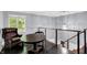 Loft area with hardwood floors, complemented by a cozy chair and decorative chandelier at 8924 Stormhaven Ct, Indianapolis, IN 46256