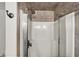 Shower stall with tile surround, chrome fixtures, and sliding glass doors at 8924 Stormhaven Ct, Indianapolis, IN 46256
