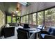 Beautiful screened-in porch with ceiling fans, skylights, comfortable seating, and views of the surrounding nature at 8924 Stormhaven Ct, Indianapolis, IN 46256