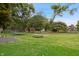 Vast backyard featuring a picnic table, trampoline, and a storage shed amidst lush greenery at 9189 Dawn Dr, Brownsburg, IN 46112