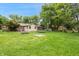 Large backyard with a sprawling lawn, picnic table, and recreational features like a trampoline at 9189 Dawn Dr, Brownsburg, IN 46112