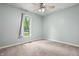 Bright bedroom with a ceiling fan, and a large window showcasing the outdoor scenery at 9189 Dawn Dr, Brownsburg, IN 46112