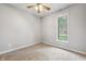 Cozy bedroom with carpet flooring, neutral walls, and a large window overlooking the neighborhood at 9189 Dawn Dr, Brownsburg, IN 46112