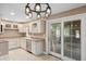Well-lit kitchen equipped with white cabinets, stainless steel appliances, and a convenient access door at 9189 Dawn Dr, Brownsburg, IN 46112
