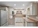 Bright kitchen featuring white cabinets, tile flooring, and modern appliances for a functional cooking space at 9189 Dawn Dr, Brownsburg, IN 46112