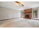 Bright living room boasts a brick fireplace, neutral carpet, and a ceiling fan for added comfort at 9189 Dawn Dr, Brownsburg, IN 46112