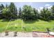 Lush backyard featuring mature trees and a swing set for outdoor fun at 9215 Stones Bluff Pl, Indianapolis, IN 46113