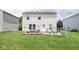 The backyard has a patio area with seating, a grill, and a play set at 9215 Stones Bluff Pl, Indianapolis, IN 46113