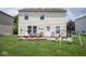 The backyard features a patio, grill, flowers, and play set at 9215 Stones Bluff Pl, Indianapolis, IN 46113