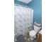 Small bathroom with toilet, shower and mobility aids at 9215 Stones Bluff Pl, Indianapolis, IN 46113